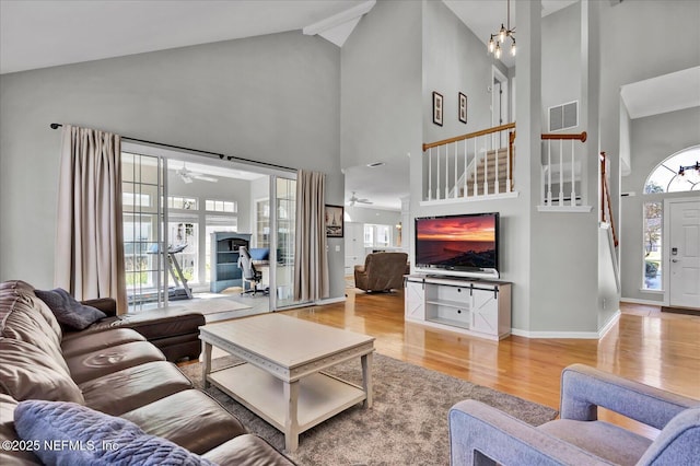 living room featuring visible vents, a healthy amount of sunlight, light wood-type flooring, and ceiling fan