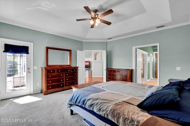 bedroom with crown molding, ceiling fan, a tray ceiling, carpet floors, and access to outside