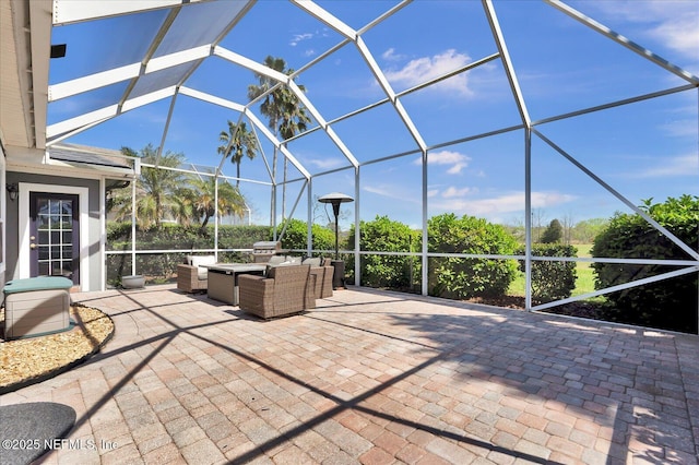 view of patio / terrace featuring glass enclosure and outdoor lounge area