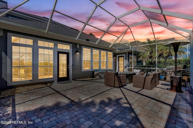 view of patio with glass enclosure and outdoor lounge area