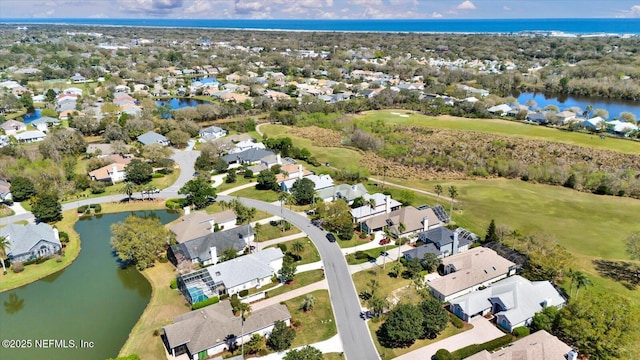 birds eye view of property featuring a water view and a residential view