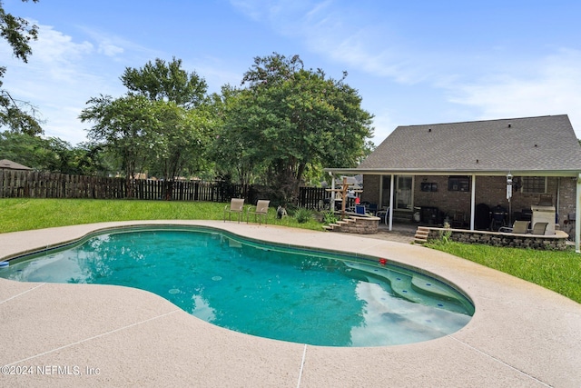 view of swimming pool with a patio area, a fenced backyard, a fenced in pool, and a yard