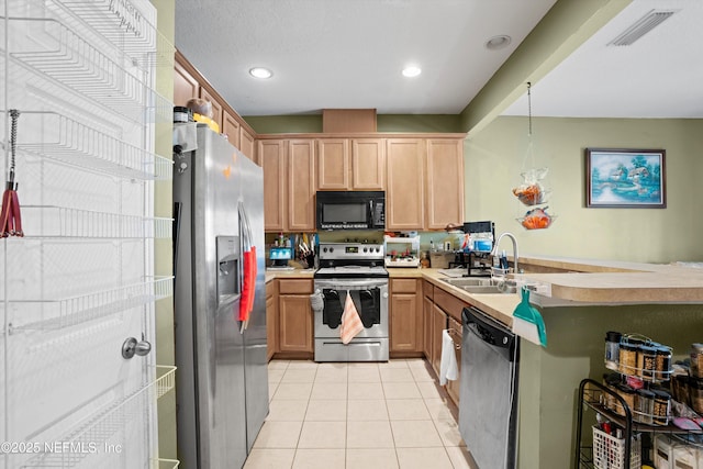 kitchen featuring light tile patterned floors, visible vents, appliances with stainless steel finishes, a sink, and a peninsula