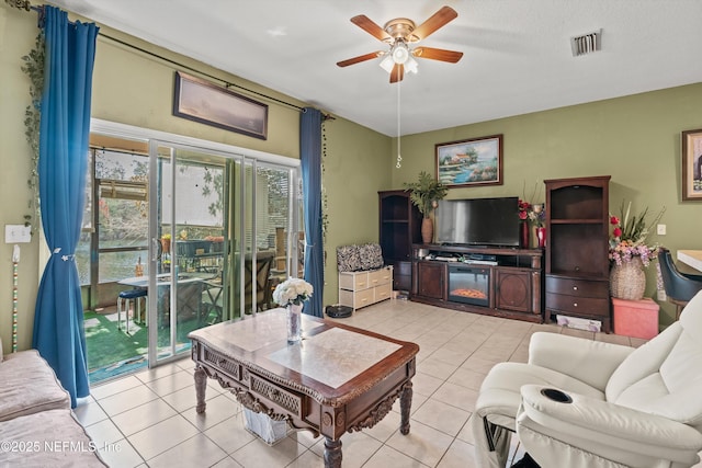 living area featuring a ceiling fan, visible vents, and light tile patterned flooring