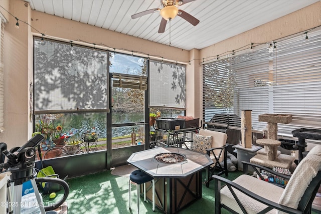 sunroom / solarium featuring ceiling fan