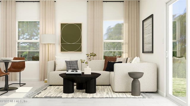 living area featuring plenty of natural light, wood finished floors, and baseboards