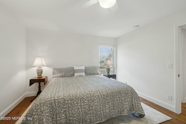 bedroom with baseboards, wood finished floors, and a ceiling fan