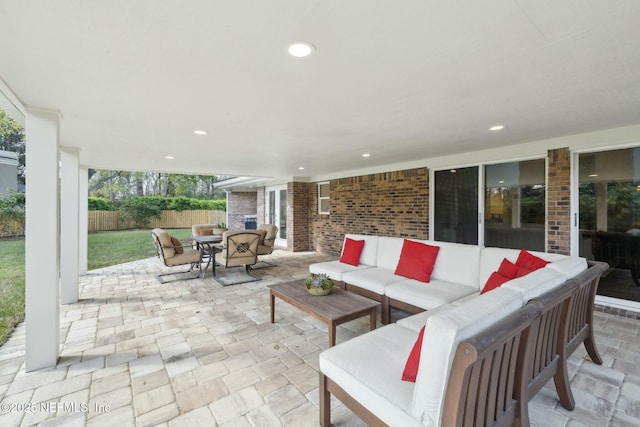 view of patio featuring outdoor lounge area, outdoor dining area, and fence