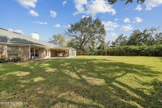 view of yard featuring a patio area and fence