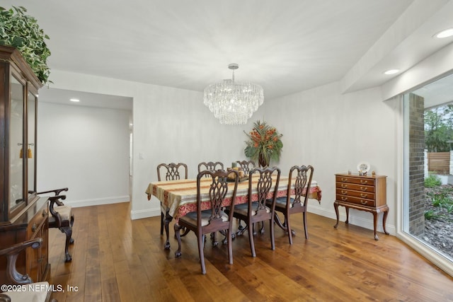 dining space with a notable chandelier, recessed lighting, baseboards, and hardwood / wood-style flooring