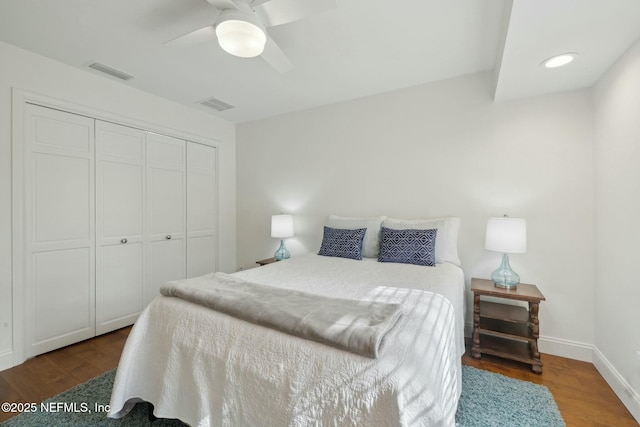 bedroom featuring a closet, visible vents, and wood finished floors