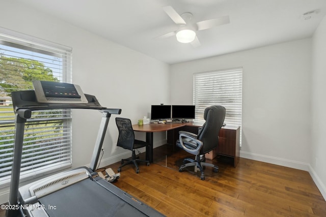 office space featuring a ceiling fan, baseboards, and wood finished floors