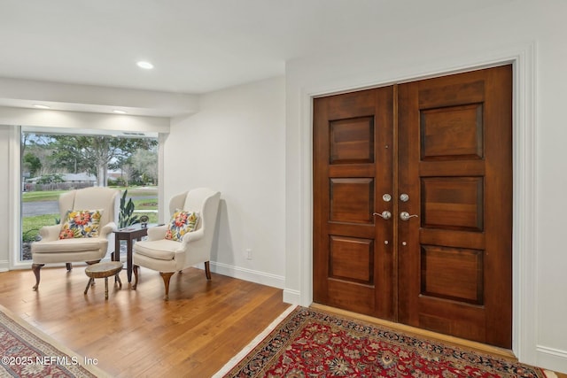 foyer entrance with recessed lighting, baseboards, and wood finished floors