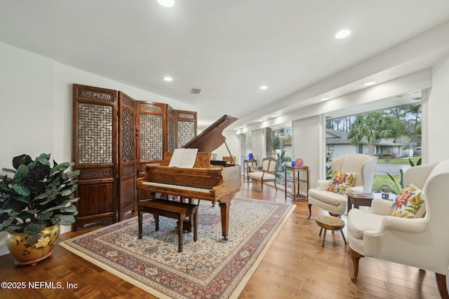 sitting room with recessed lighting, wood finished floors, and visible vents