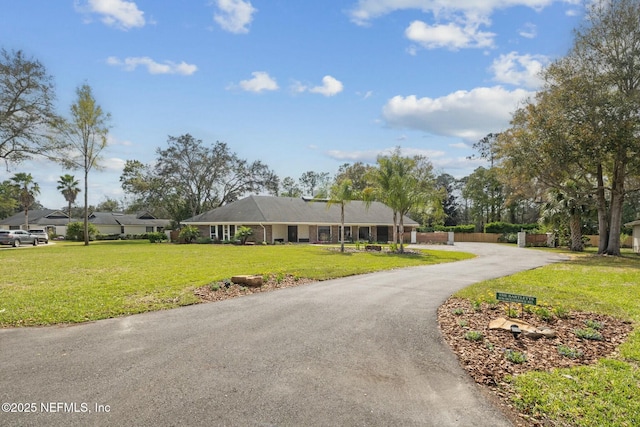 single story home featuring a front lawn and driveway