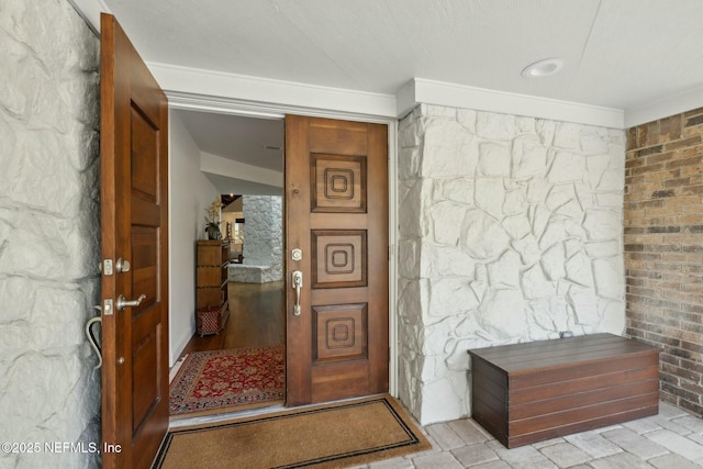 entryway featuring ornamental molding