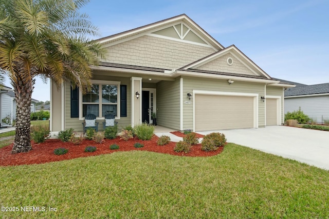 view of front of home featuring driveway, an attached garage, and a front lawn