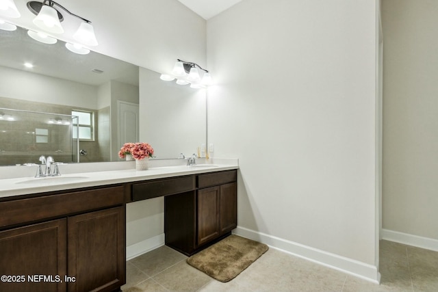 bathroom with double vanity, tile patterned floors, a sink, and tiled shower