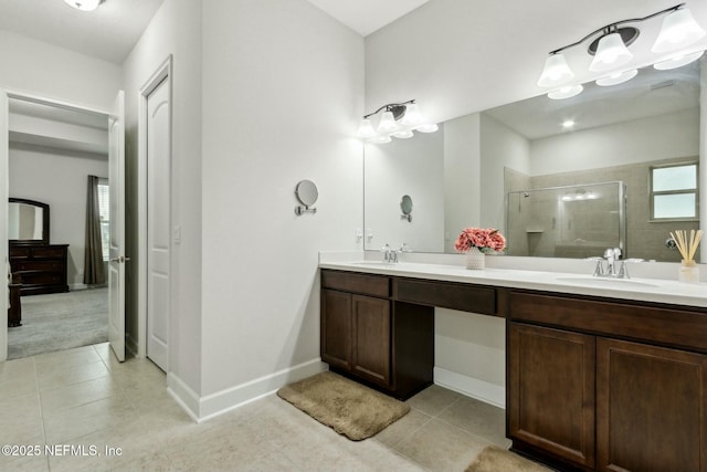 full bathroom featuring tile patterned floors, a sink, and a shower stall