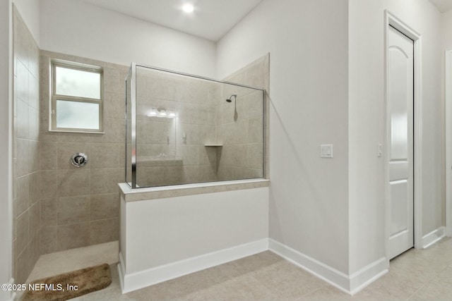 bathroom featuring baseboards and walk in shower