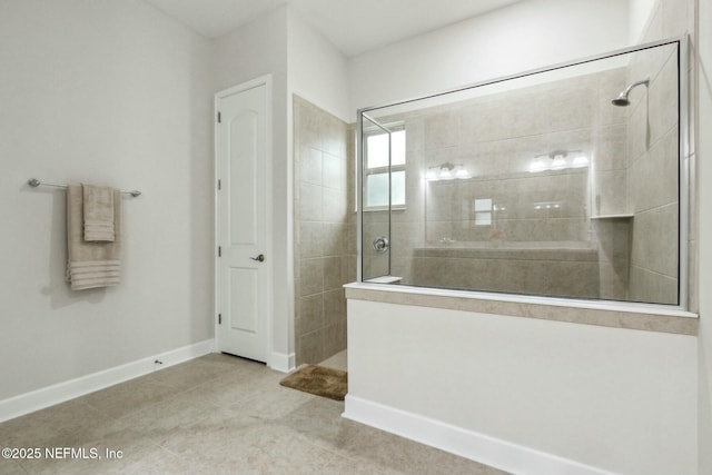 bathroom featuring tile patterned flooring, baseboards, and walk in shower