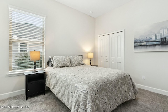 bedroom with a closet, carpet flooring, and baseboards