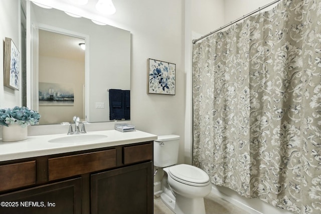 bathroom featuring toilet and vanity