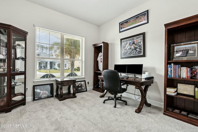 carpeted office featuring baseboards