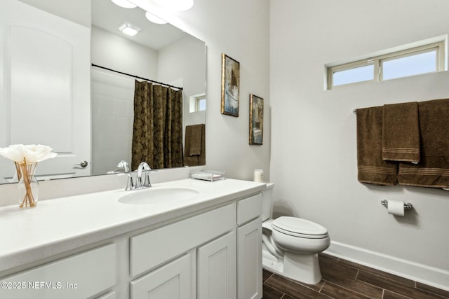 full bathroom with curtained shower, toilet, vanity, baseboards, and wood tiled floor