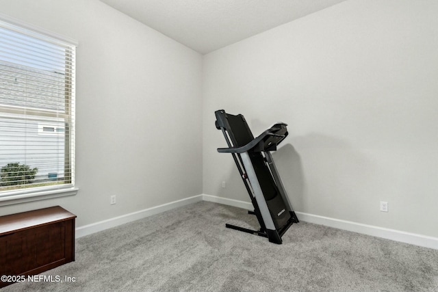 exercise room featuring carpet floors and baseboards