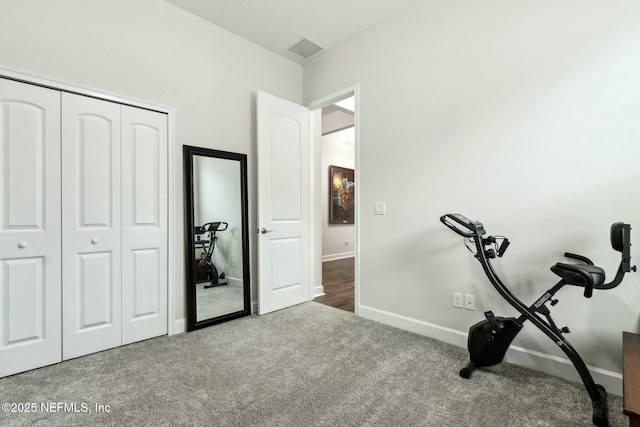 exercise area featuring carpet, visible vents, and baseboards