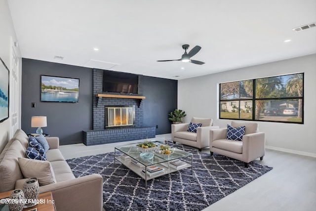 living area featuring ceiling fan, recessed lighting, a fireplace, visible vents, and baseboards