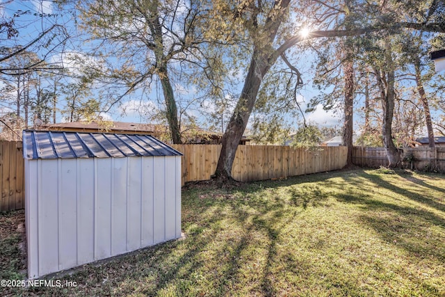 view of yard featuring a fenced backyard, a shed, and an outdoor structure