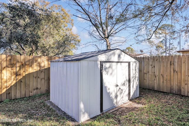 view of shed with a fenced backyard