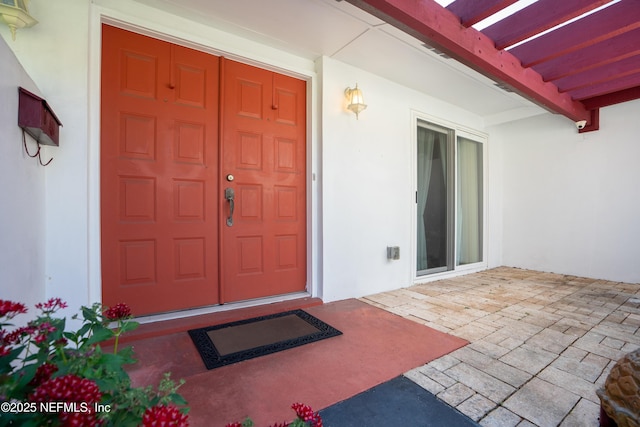 property entrance with stucco siding