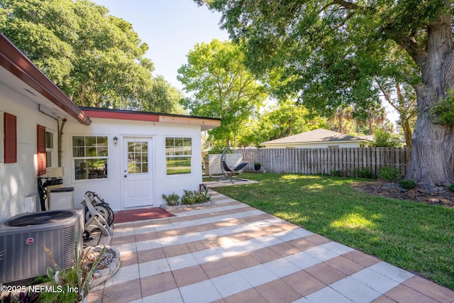 exterior space with a patio area, cooling unit, and fence