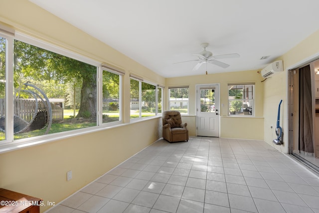 unfurnished sunroom featuring ceiling fan and a wall mounted air conditioner