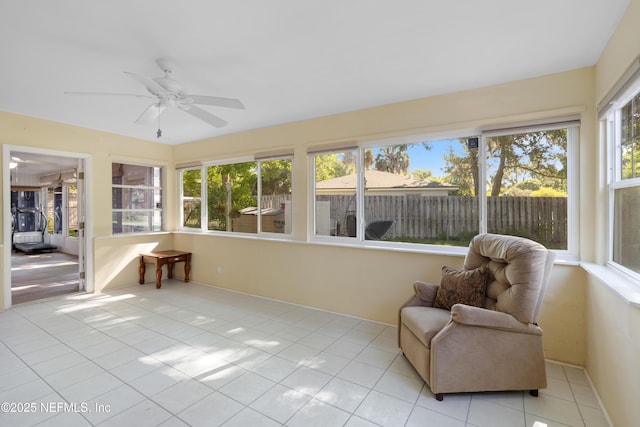 sunroom / solarium with a ceiling fan