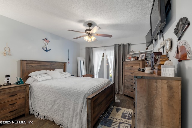 bedroom featuring dark wood-style floors, a ceiling fan, and a textured ceiling