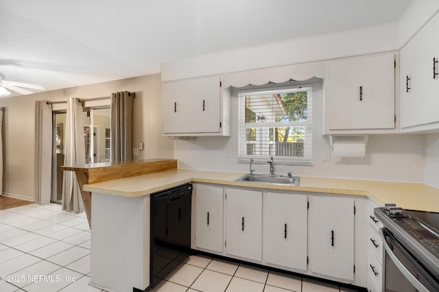 kitchen featuring tasteful backsplash, dishwasher, a peninsula, light countertops, and a sink