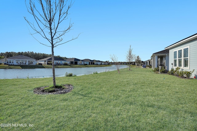 view of yard with a water view and a residential view