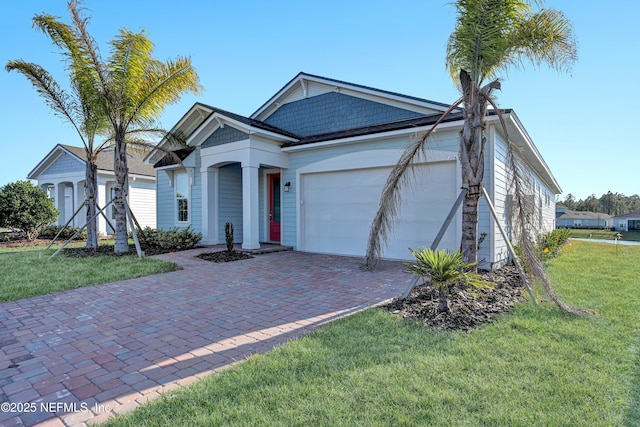 ranch-style home featuring a garage, driveway, and a front yard