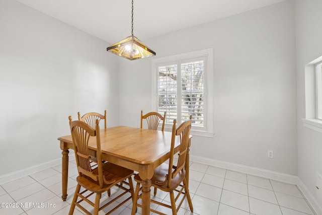 dining space featuring light tile patterned floors and baseboards