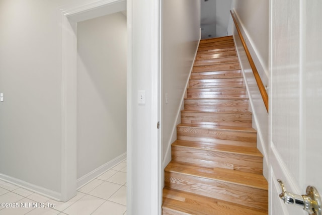 staircase with tile patterned flooring and baseboards