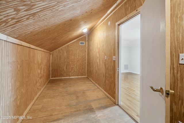 bonus room with lofted ceiling, wood walls, light wood-type flooring, and wood ceiling