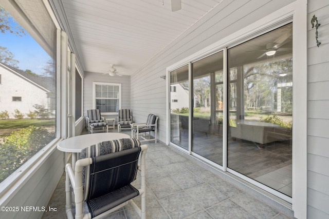 sunroom with a ceiling fan