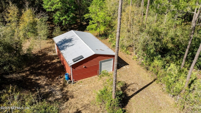 birds eye view of property featuring a view of trees