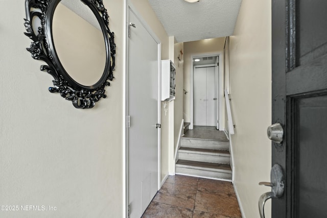 2211 1st St S, Jacksonville Beach, FL 32250 - hall with a textured ceiling, baseboards, and stairway