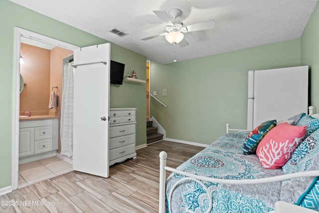 2211 1st St S, Jacksonville Beach, FL 32250 - bedroom featuring visible vents, freestanding refrigerator, wood finished floors, and a textured ceiling