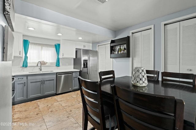 2211 1st St S, Jacksonville Beach, FL 32250 - kitchen with open shelves, gray cabinets, a sink, light countertops, and stainless steel appliances
